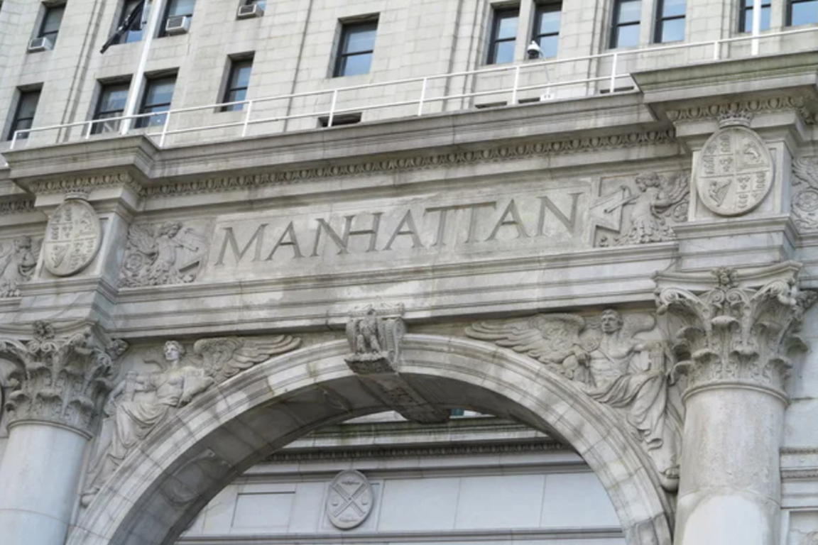 BUILDING VIEW OF A BUILDING WITH THE WORDS MANHATTAN ENGRAVED