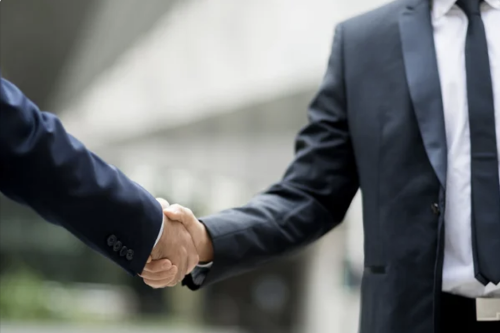 Criminal Lawyer Glenn Hardy shaking hands with a client in NYC train subway