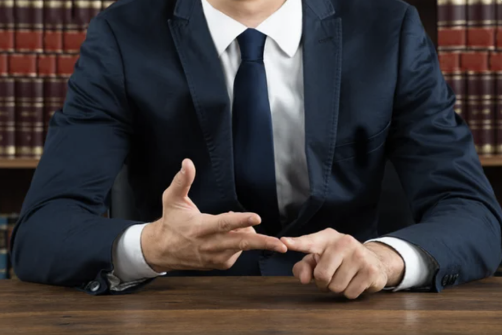 NYC Lawyer showing with fingers steps on a trial